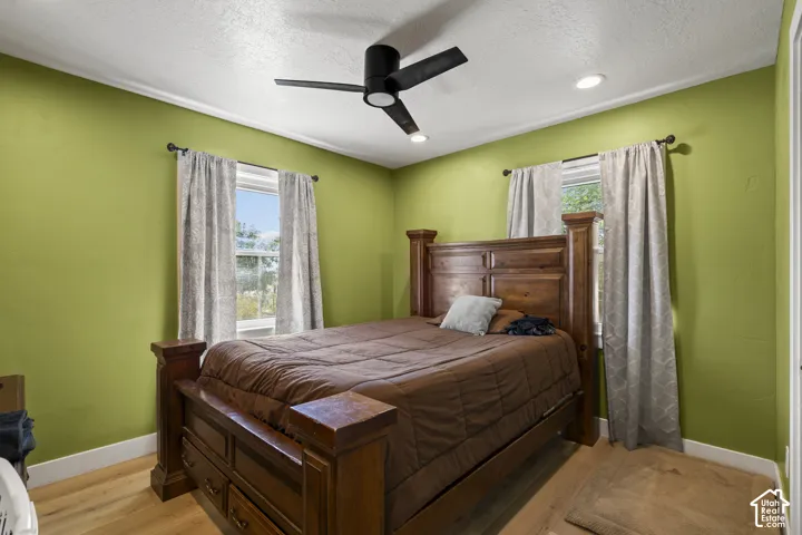 Recessed lighting, ceiling fan, crown molding, wood-finish flooring, two windows