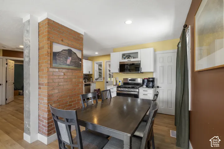 Exposed brick accent wall with wood-finish flooring