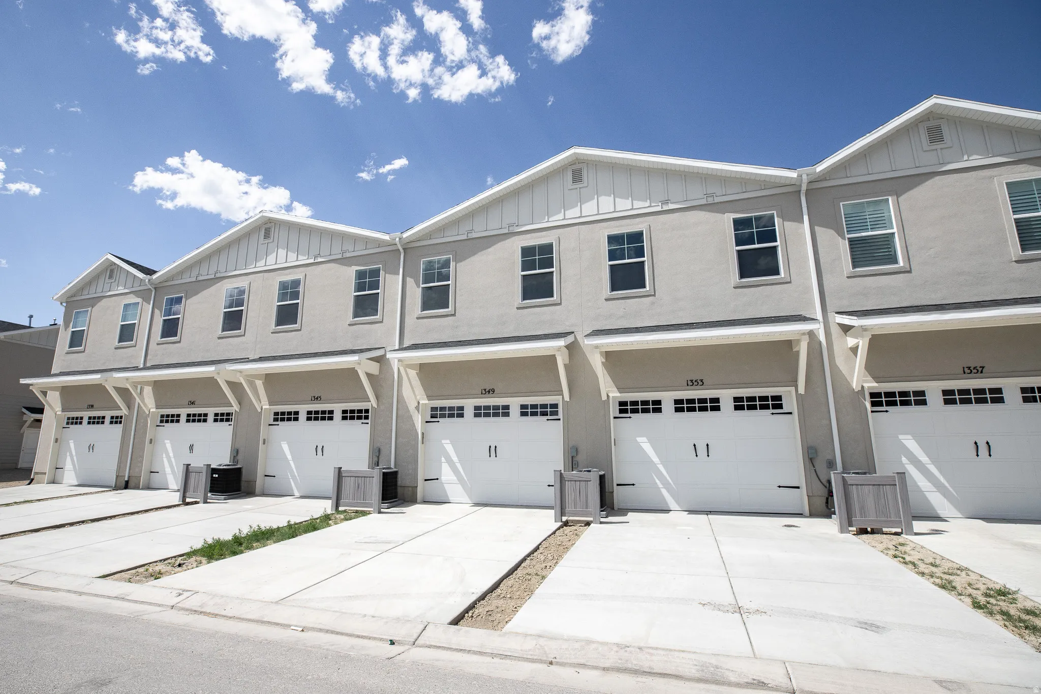 Rear view of building with garage and extra-long driveway.