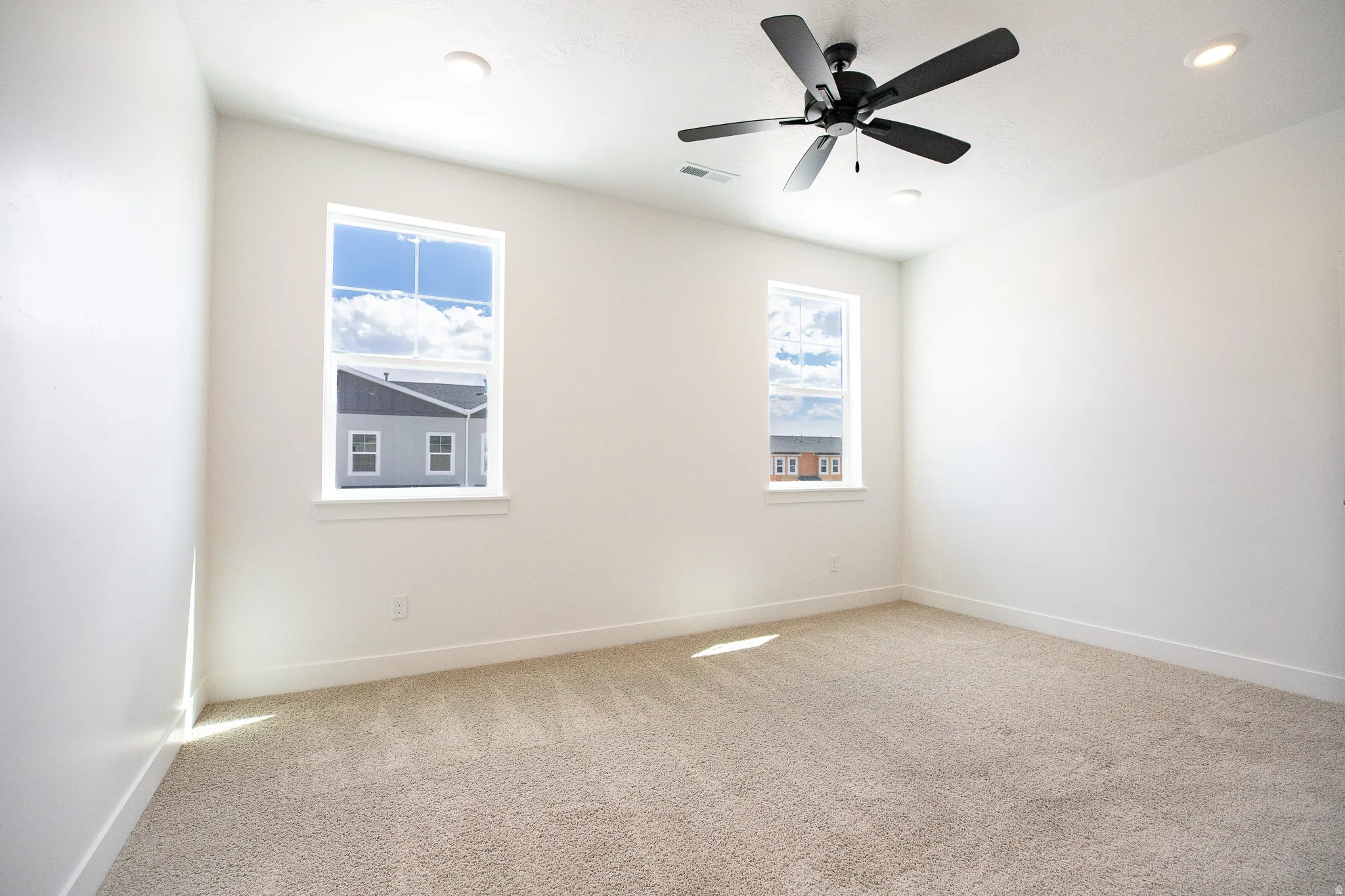 Primary bedroom with 9' ceiling and ceiling fan.