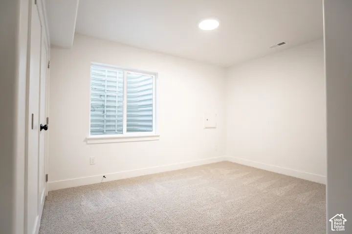 Bedroom #3 in fully-finished basement with large closet.