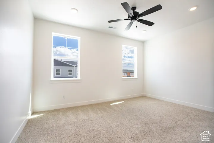 Primary bedroom with 9' ceiling and ceiling fan.