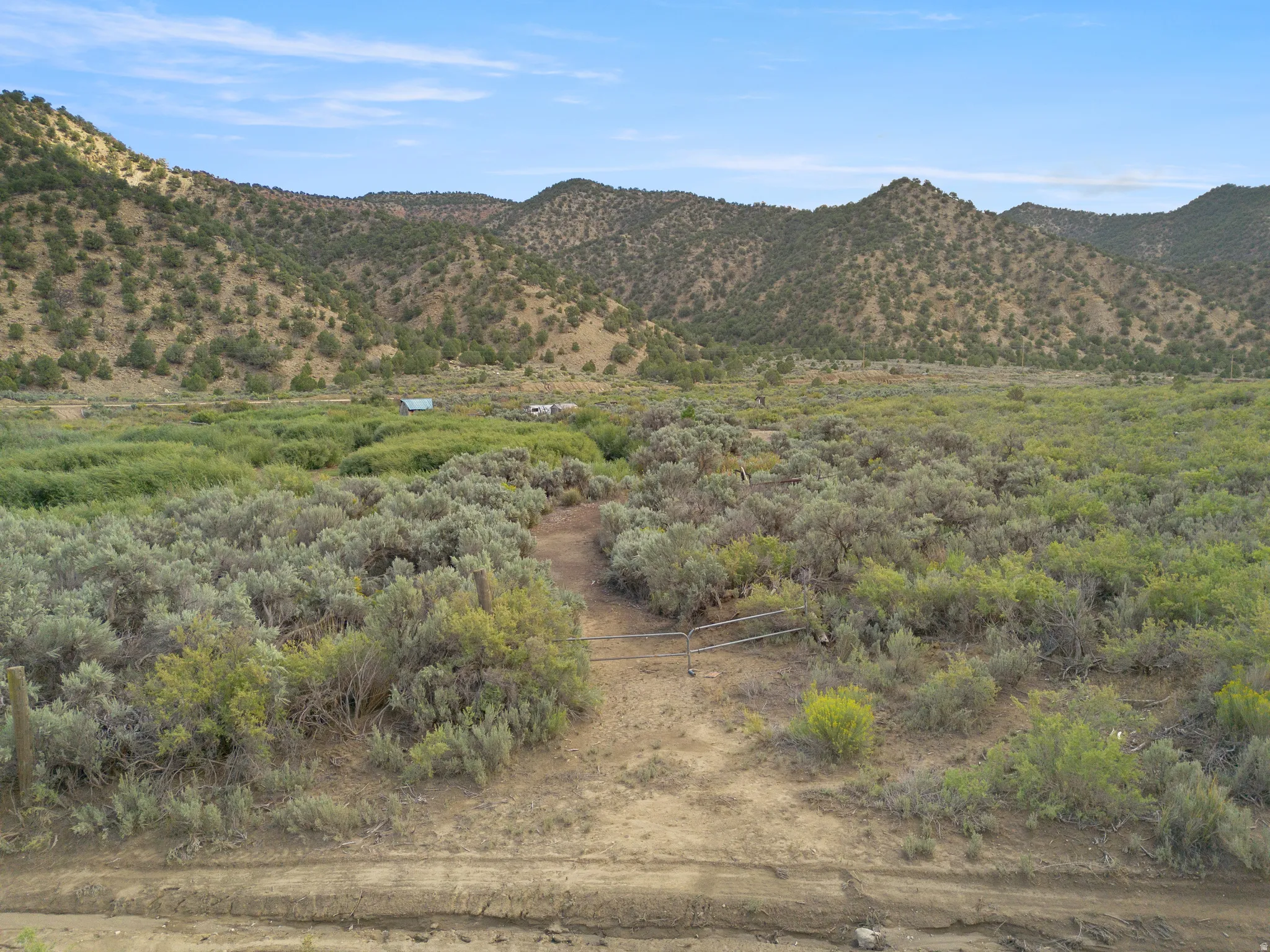 Expansive landscape featuring rolling hills and abundant shrubbery