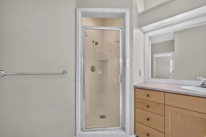 Glass-enclosed shower with tile surround and integrated niche