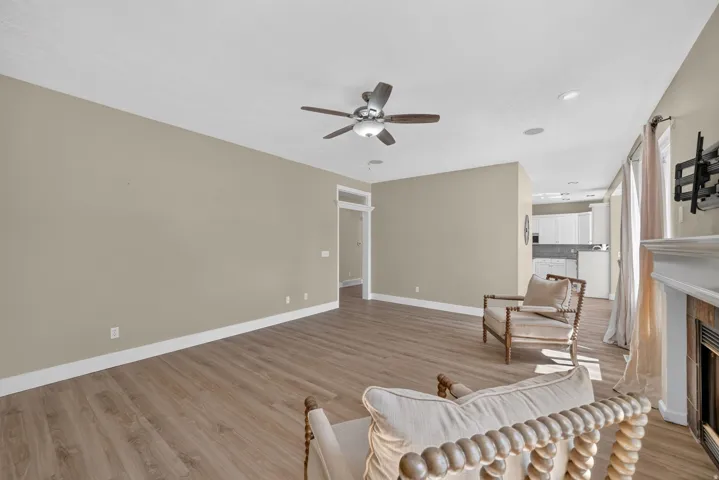 Open concept living area featuring wood-finish flooring, recessed lighting, and a ceiling fan