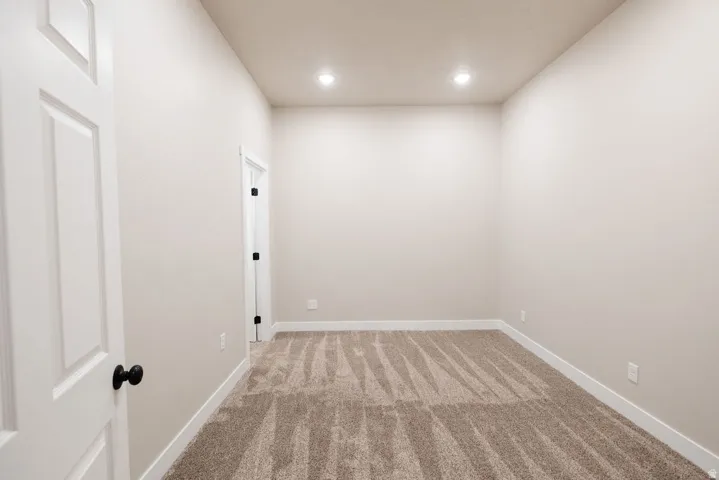 Neutral-toned walls complement plush carpet flooring