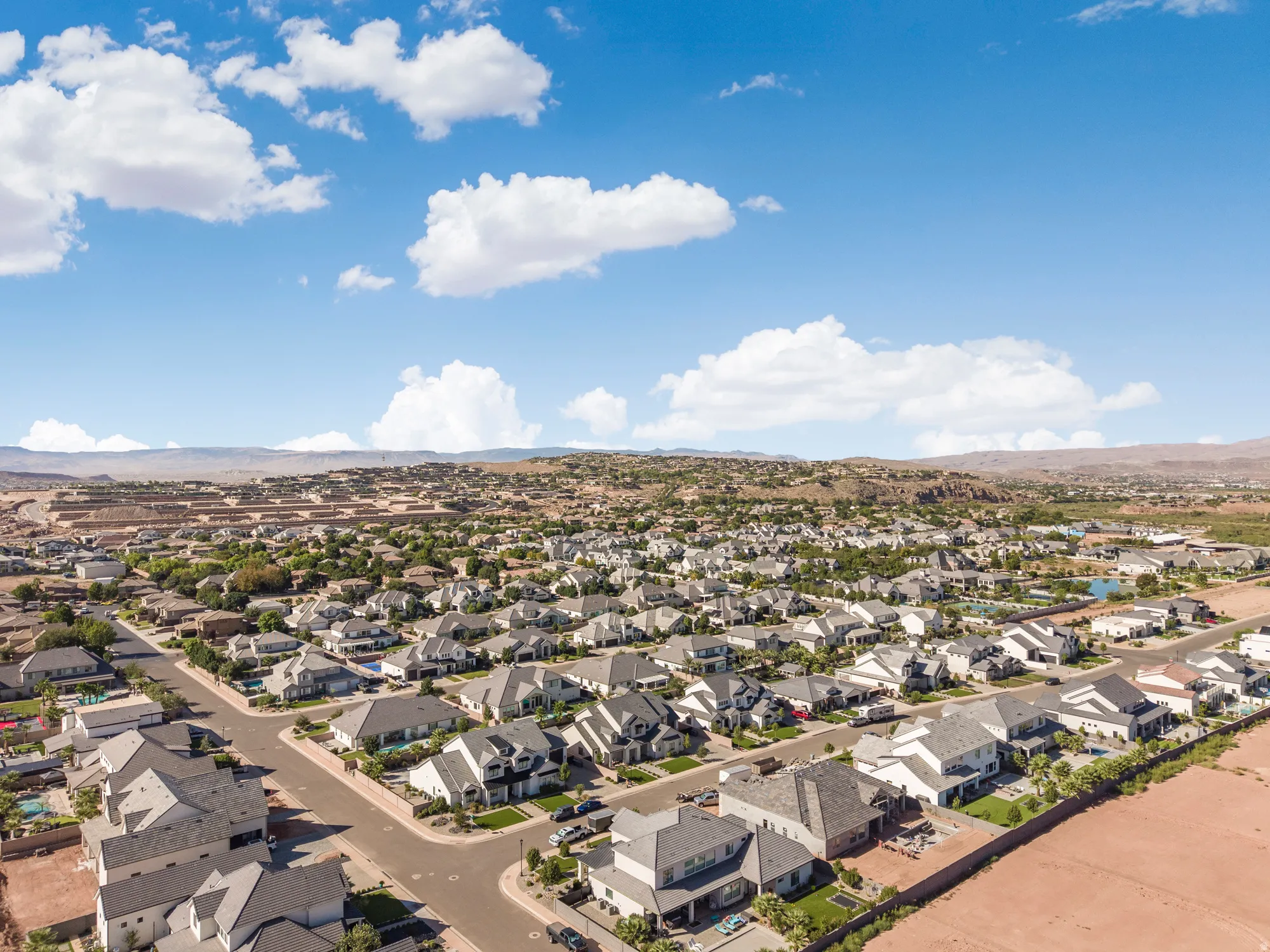 Residential neighborhood featuring a variety of single-family homes, paved streets, and mature landscaping