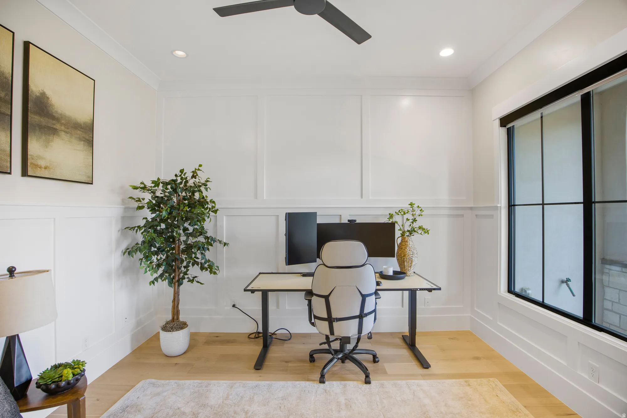 Recessed lighting, wood-finish flooring, ceiling fan, grid-pattern window, and wainscoting