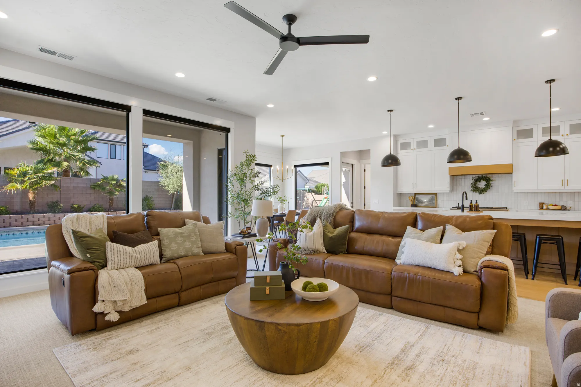 Spacious interior with high ceilings, recessed lighting, and large sliding glass doors