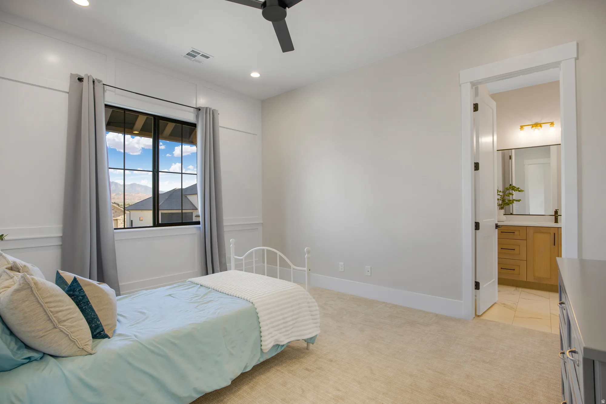 Plush carpeted flooring, a black ceiling fan, recessed lighting, and a window with black grilles