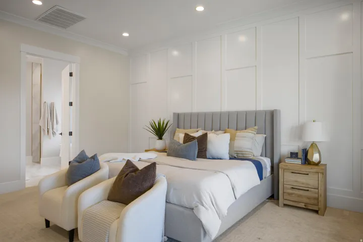 Recessed lighting throughout, crown molding, and wainscoting detail