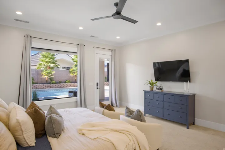Recessed lighting illuminates the room, complemented by a ceiling fan