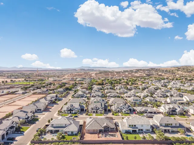 Expansive neighborhood with diverse architectural styles, mature landscaping, and mountain backdrop