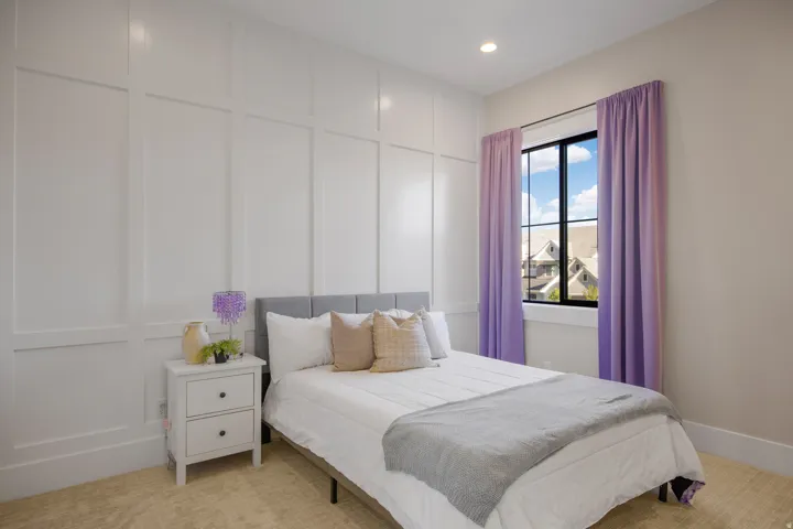 Board and batten wall detailing, recessed ceiling lighting, and a window with dark framing