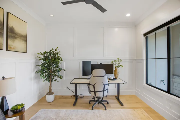 Recessed lighting, wood-finish flooring, ceiling fan, grid-pattern window, and wainscoting