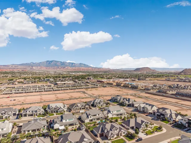 Expansive residential development featuring a variety of architectural styles, mature landscaping, and mountain backdrops
