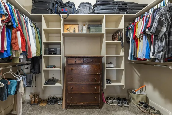 Built-in closet system featuring multiple shelving units and hanging rods