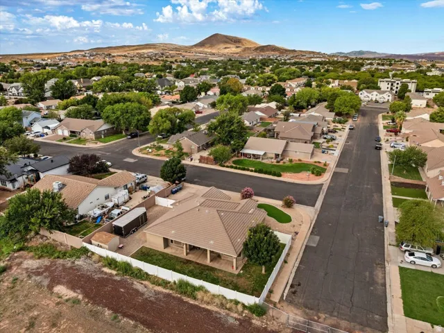 Single-story residence with a covered patio, tile roof, and a fenced perimeter