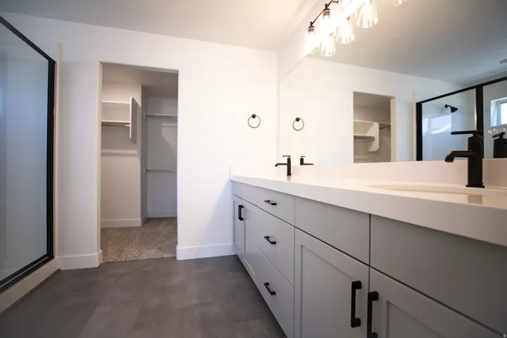 Primary bath with large walk-in shower and dual vanity