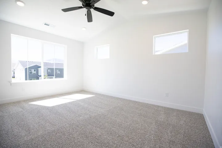 Primary bedroom with vaulted ceilings