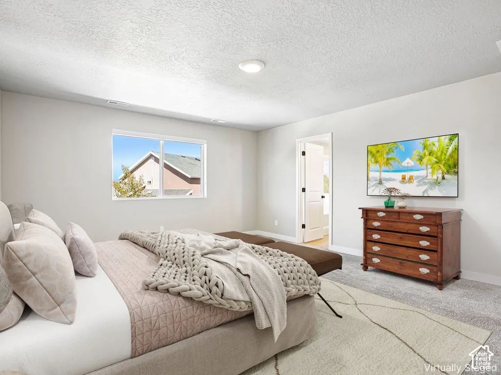 Recessed ceiling lighting, white walls, and light-toned carpeting