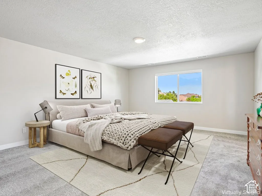 Wall-to-wall carpeting in a neutral tone, white walls, and a recessed ceiling light