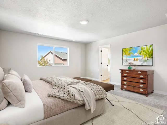 Recessed ceiling lighting, white walls, and light-toned carpeting