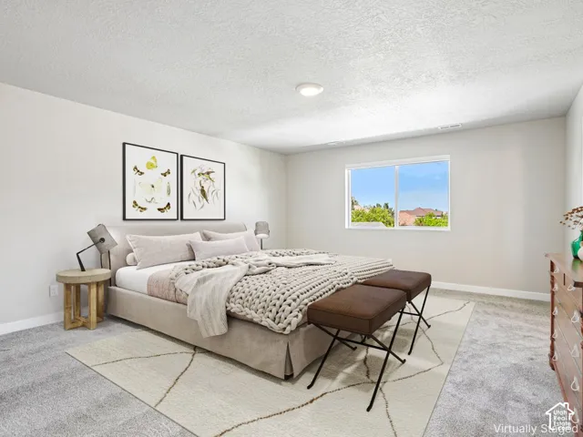 Wall-to-wall carpeting in a neutral tone, white walls, and a recessed ceiling light