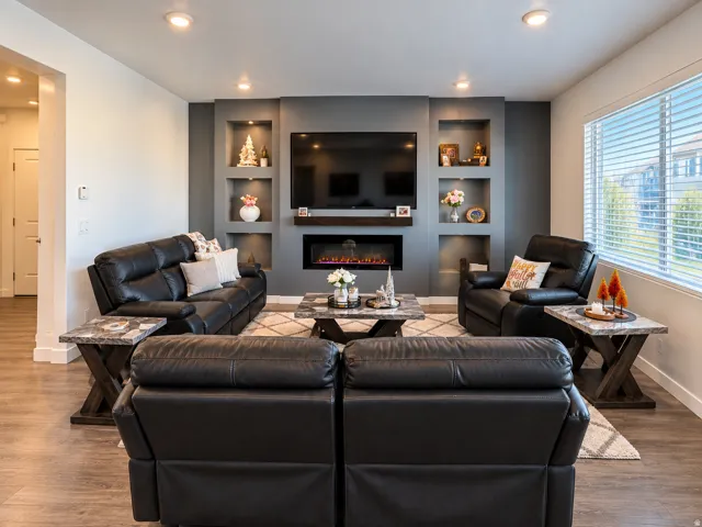Accent wall featuring integrated shelving with recessed lighting