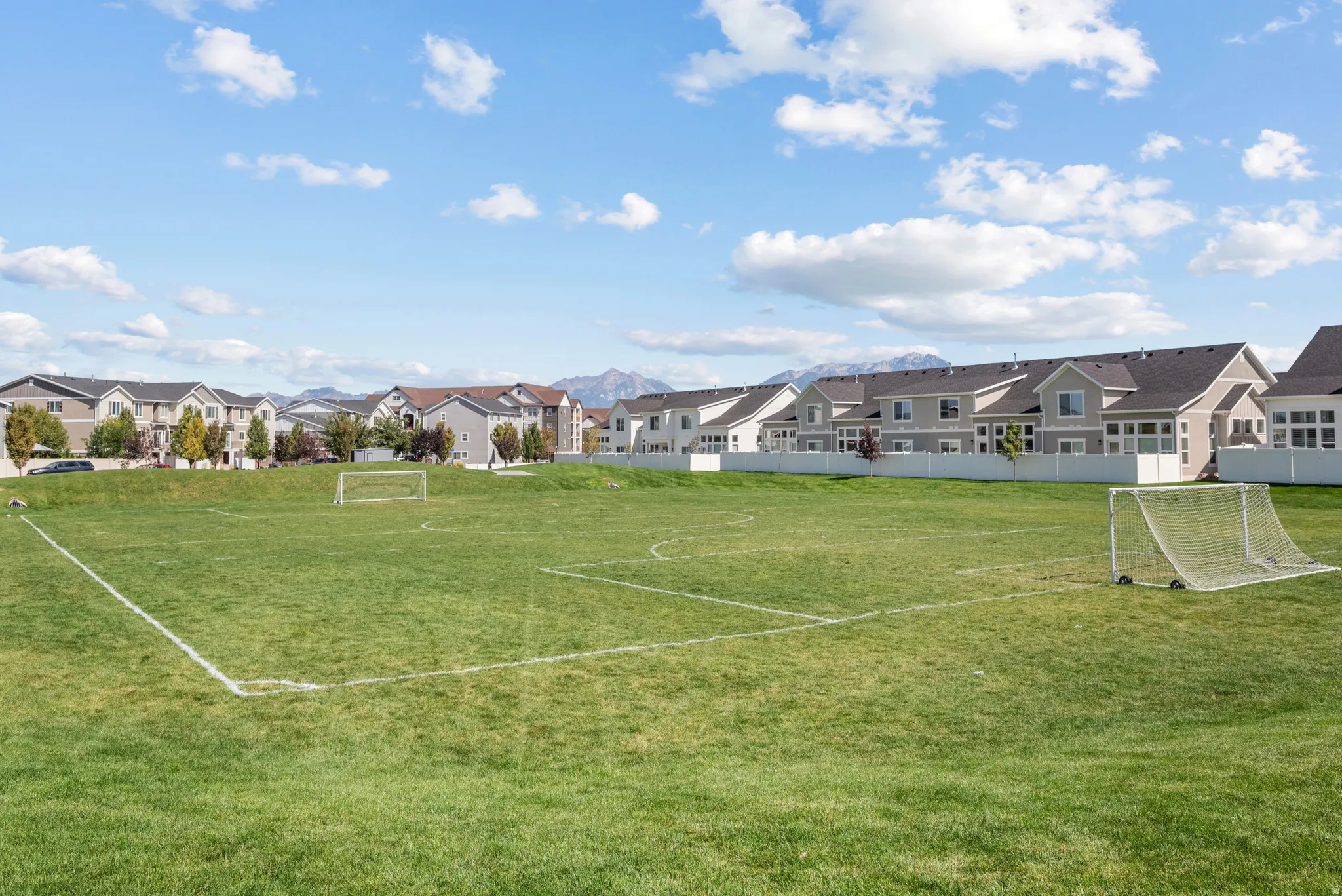 Expansive green field with marked boundaries and two goalposts