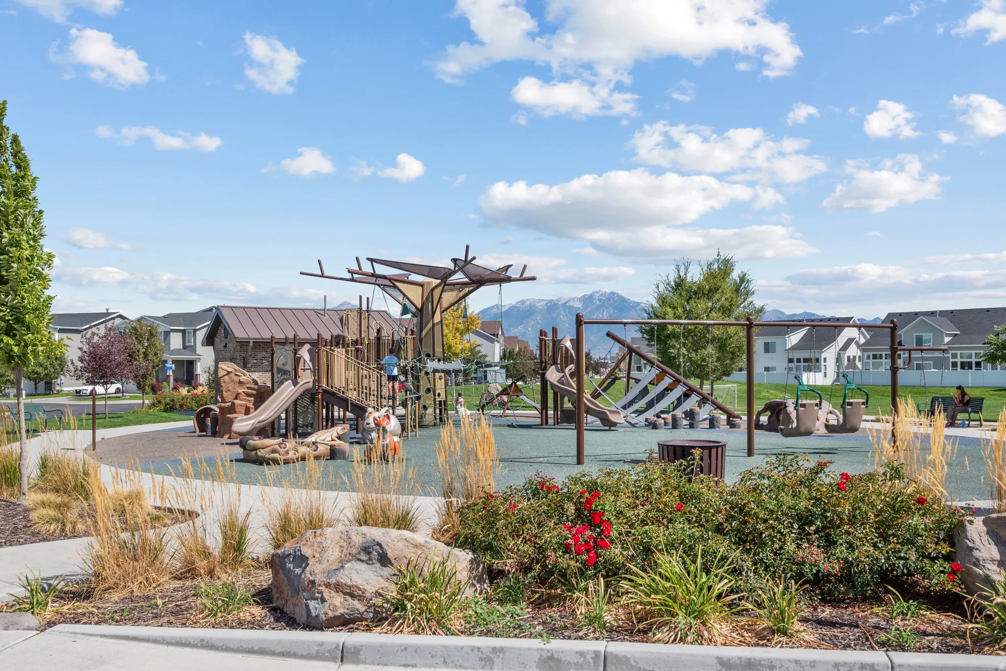 Community playground with multiple play structures, swings, and slides