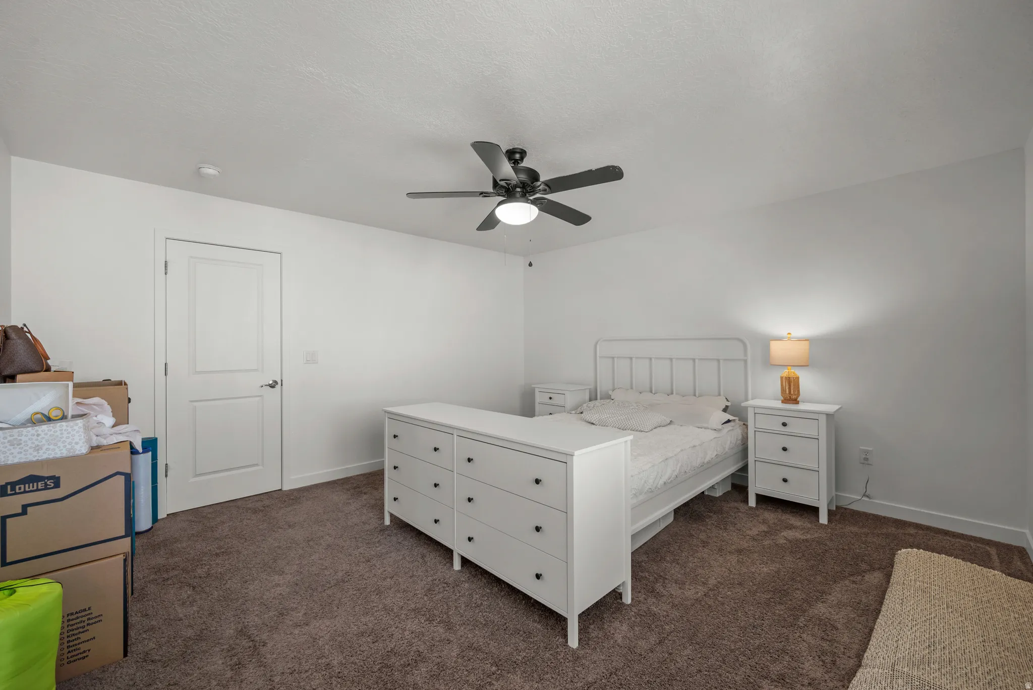 Recessed panel door, ceiling fan with integrated lighting, and neutral tone walls
