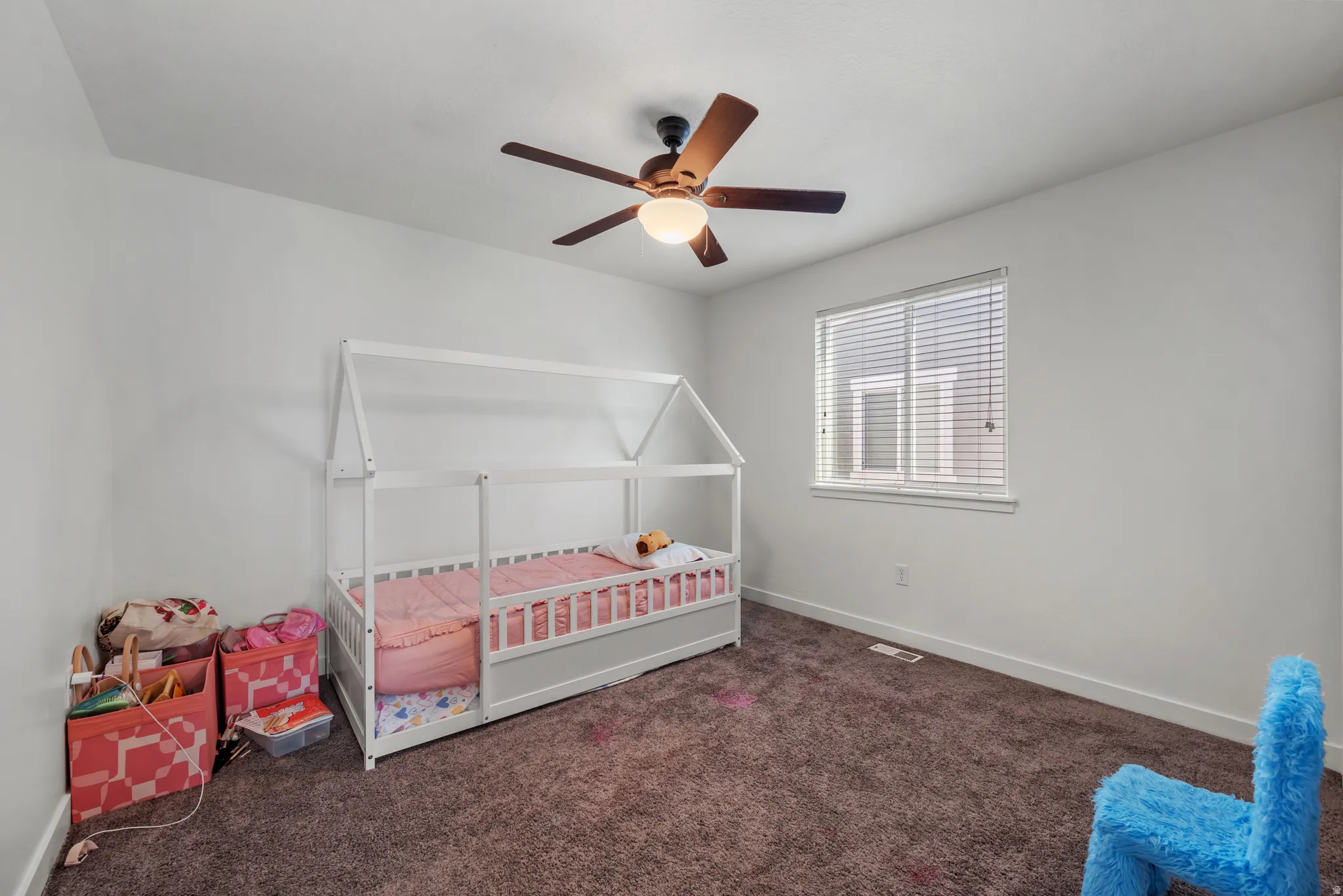 Recessed ceiling, window with blinds, and a ceiling fan with integrated lighting