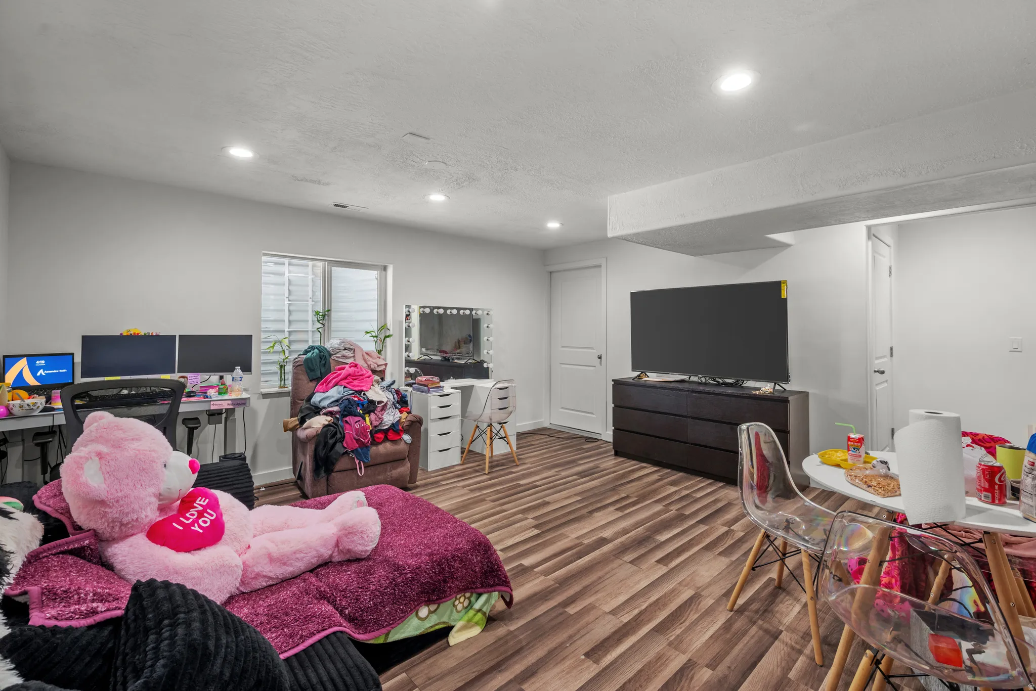 Wood-finish flooring throughout, recessed lighting, and a window with horizontal blinds