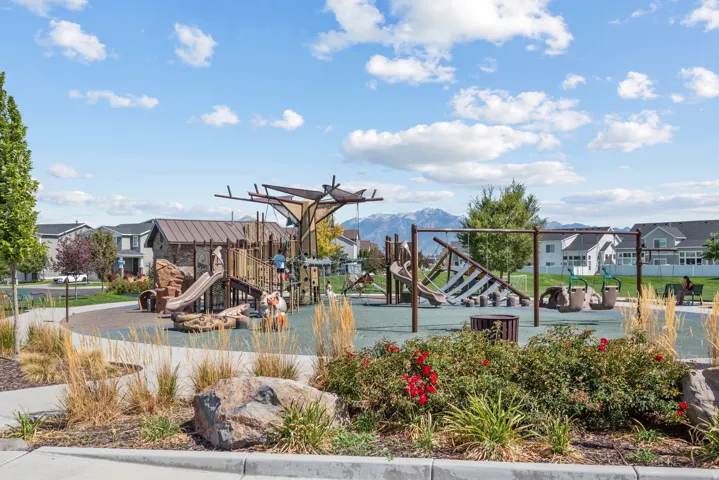 Community playground with multiple play structures, swings, and slides