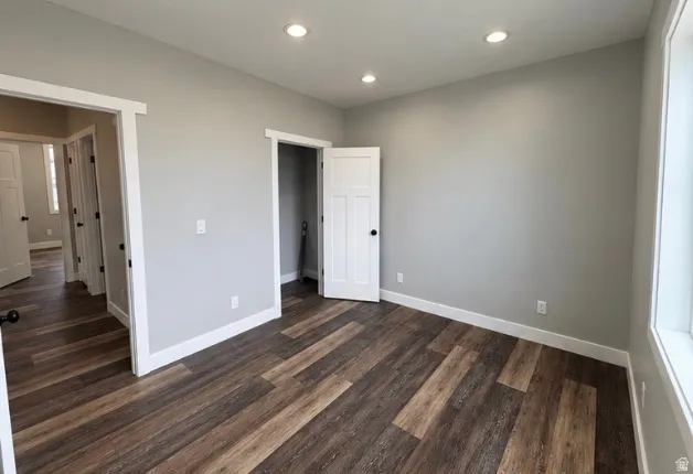 Wood-finish flooring, recessed lighting, and crisp white trim