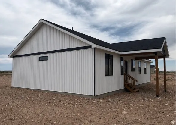 Modern exterior featuring crisp white vertical siding and black trim accents