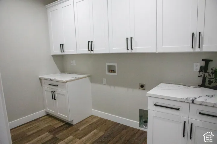 White shaker cabinetry with black hardware, wood-finish flooring, and white countertops