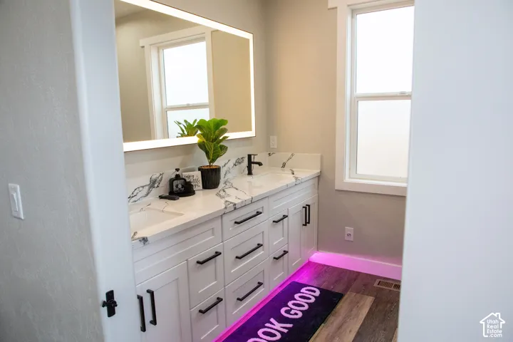Dual vanity with white shaker-style cabinetry, black hardware, and integrated sinks