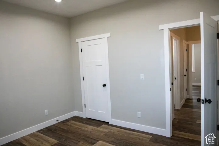 Recessed ceiling light, wood-finish flooring, white solid core doors, and white trim
