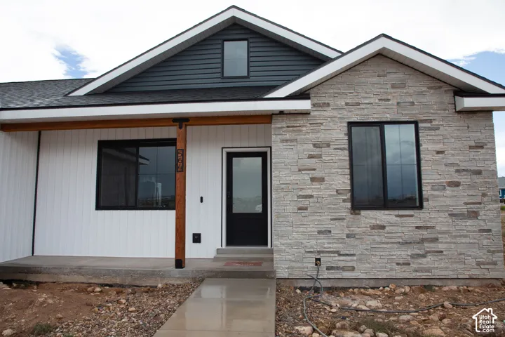Stone veneer facade with black-framed windows