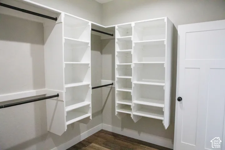 Built-in closet organization system with multiple shelves and hanging rods