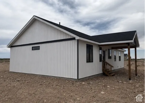Modern exterior featuring crisp white vertical siding and black trim accents