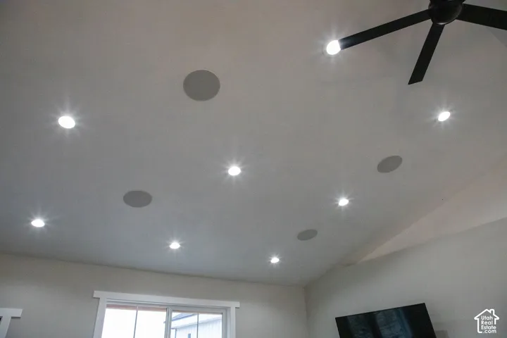 Vaulted ceiling featuring recessed lighting, integrated ceiling speakers, and a ceiling fan