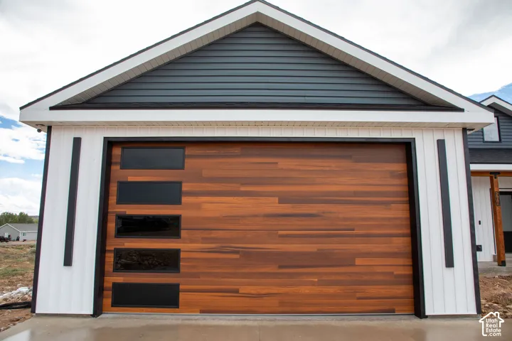Wood-finish garage door with horizontal paneling and rectangular window accents
