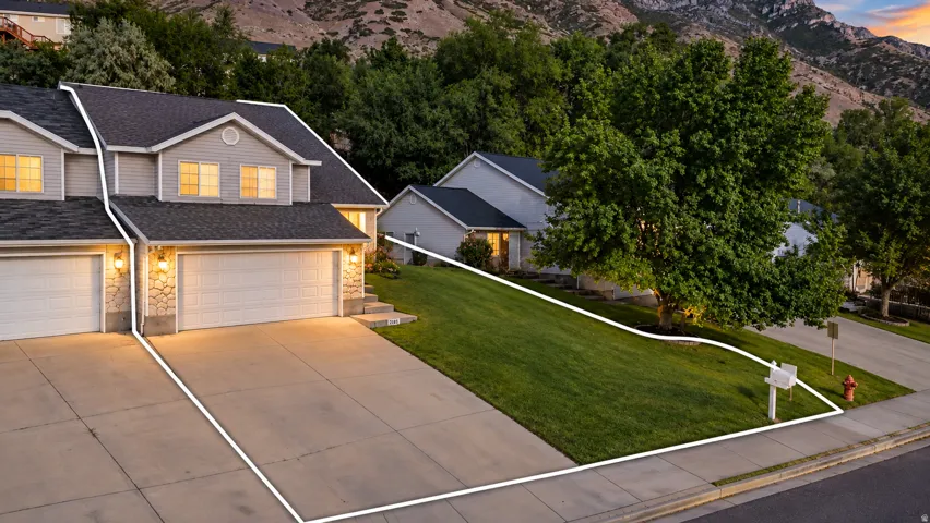 Two-story exterior with light-toned siding and stone accents