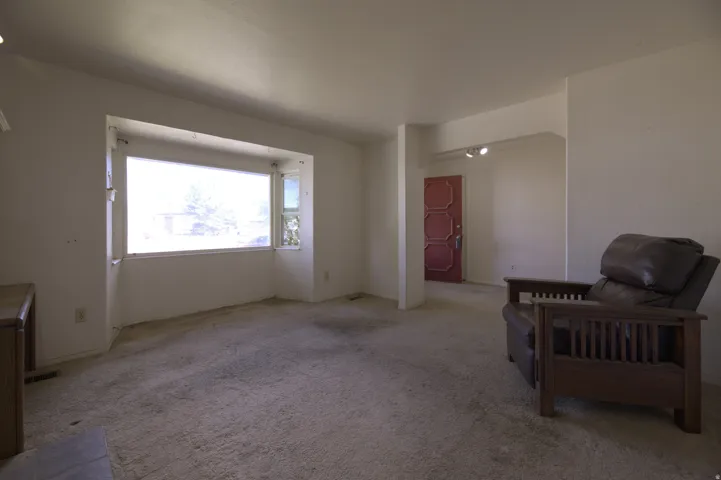 Bay window with side casement window, light-colored walls, and track lighting fixture