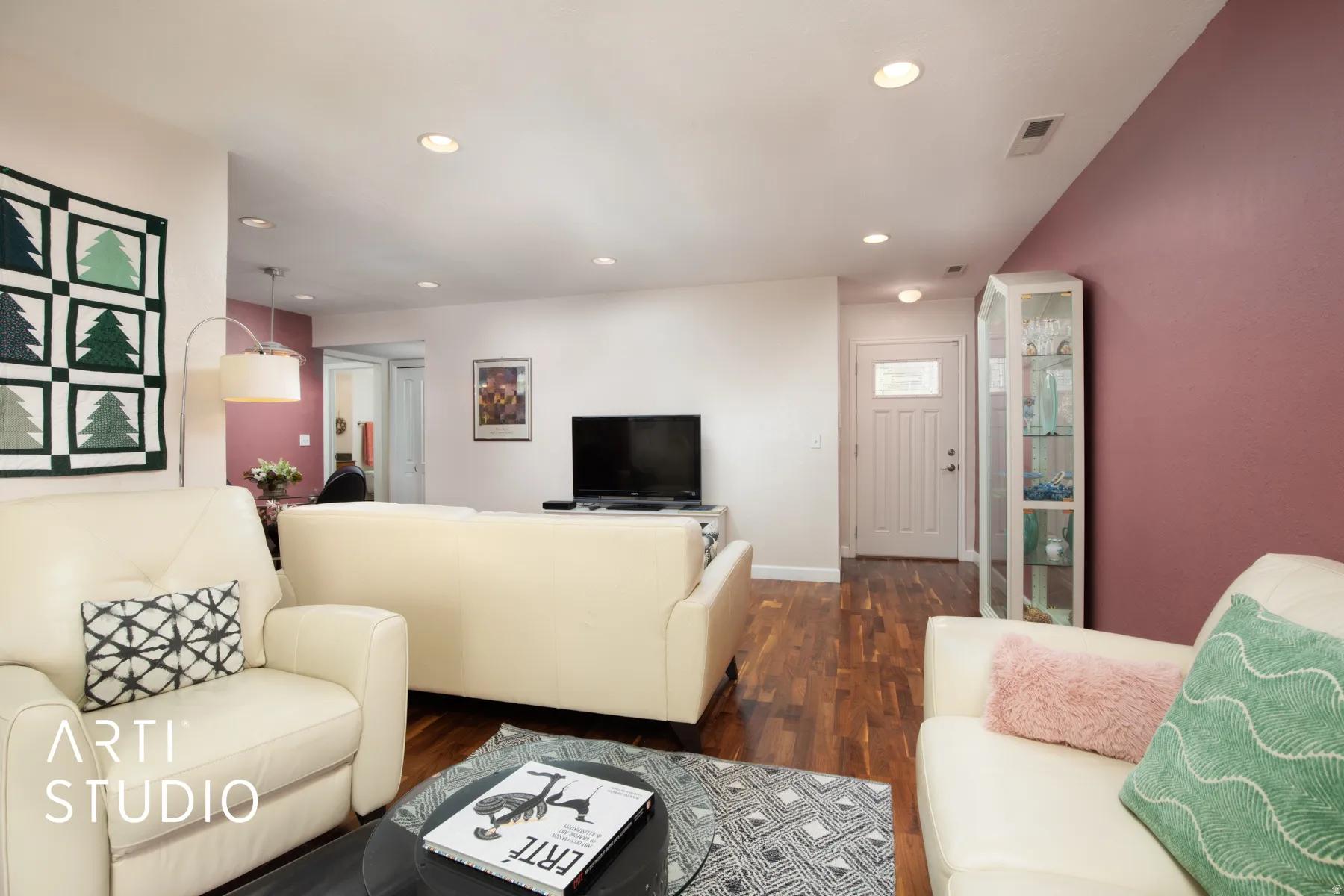 Wood-finish flooring throughout, recessed lighting, and a paneled entry door with decorative glass inserts