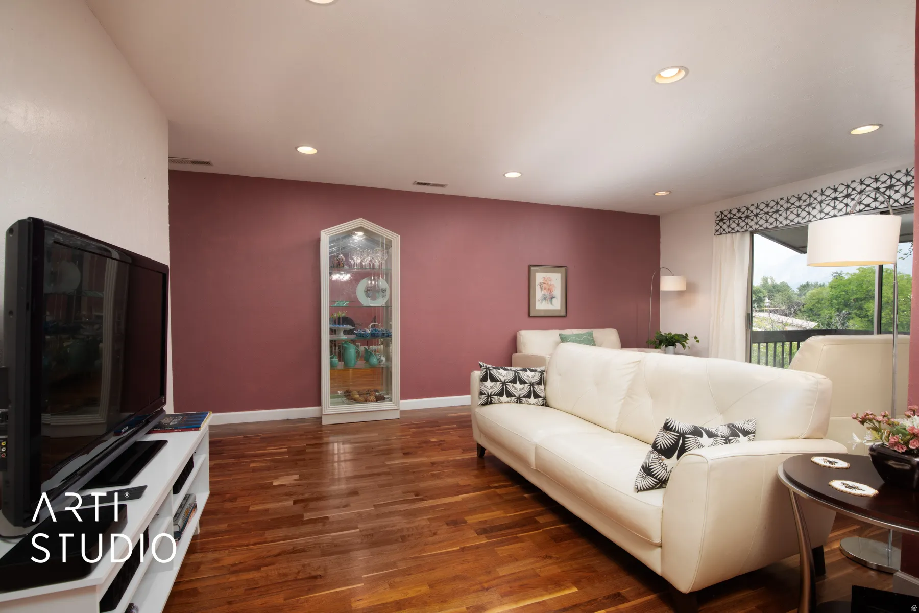 Recessed ceiling lighting, wood-finish flooring, and a built-in display cabinet