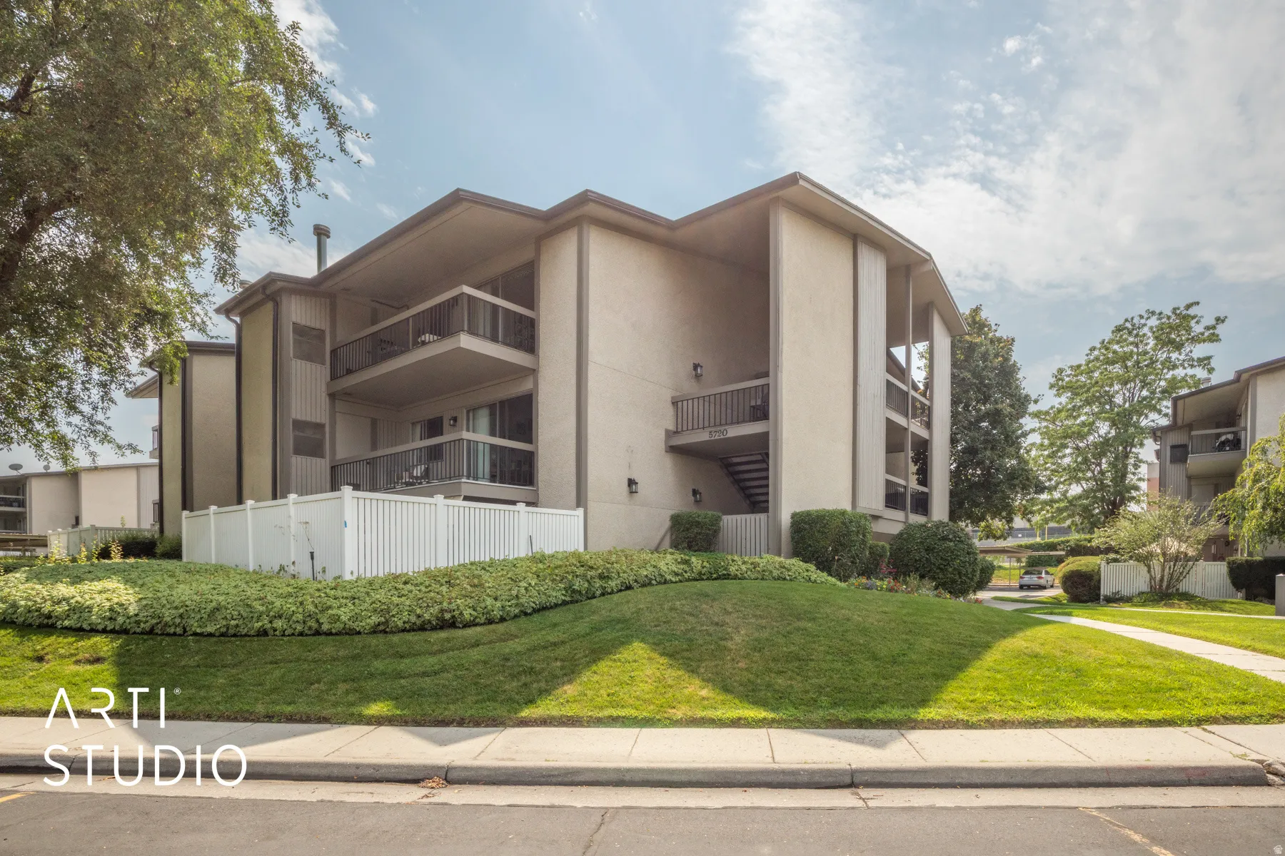 Multi-story residential building with private balconies and exterior stair access